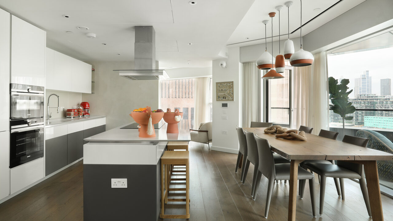Industrial por fora, boho por dentro: conheça este apê em Londres!. Projeto de Andrea Chicharo. Na foto, sala de jantar integrada à cozinha com ilha e pendentes.