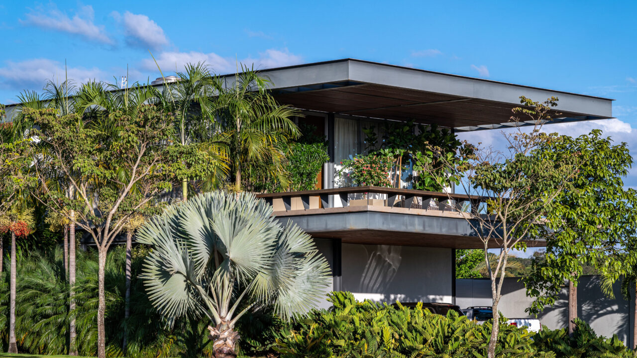 Com 1547 m², jardim mescla 47 espécies de plantas tropicais e frutíferas. Projeto de Flávia D´Urso. Na foto, varanda com jardim e fachada.